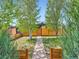 Charming front yard with a concrete walkway, a new fence, and lush green trees at 170 W Midway Blvd, Broomfield, CO 80020