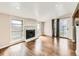 Living room with hardwood floors and featuring a stone fireplace and sliding glass doors at 170 W Midway Blvd, Broomfield, CO 80020
