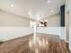 Living room featuring hardwood floors, and neutral paint with a partial view of kitchen at 170 W Midway Blvd, Broomfield, CO 80020