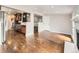 Open living room with hardwood floors, a stone fireplace, and a view of the kitchen at 170 W Midway Blvd, Broomfield, CO 80020