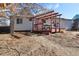 Backyard featuring a red pergola-covered deck with a picnic table at 1755 S Yampa Way, Aurora, CO 80017