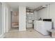 Basement laundry room featuring modern washer and dryer, and utility sink at 1755 S Yampa Way, Aurora, CO 80017