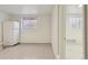 Bright basement with neutral-toned flooring, and a white refrigerator at 1755 S Yampa Way, Aurora, CO 80017