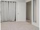 Clean and well-lit bedroom featuring carpeted floors, and a door to the laundry area at 1755 S Yampa Way, Aurora, CO 80017