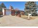 Charming brick home featuring a spacious driveway, attached garage, and well-maintained front yard at 1755 S Yampa Way, Aurora, CO 80017