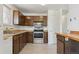 Traditional kitchen features wood cabinets, stainless steel appliances, and a breakfast bar at 1755 S Yampa Way, Aurora, CO 80017