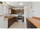 Traditional kitchen features wood cabinets, stainless steel appliances, and a breakfast bar at 1755 S Yampa Way, Aurora, CO 80017