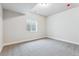 Unfinished basement room with a window and neutral colored carpet at 17751 E 93Rd Ave, Commerce City, CO 80022