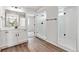 Modern bathroom with white vanity, walk-in shower, and luxury vinyl plank flooring at 17751 E 93Rd Ave, Commerce City, CO 80022