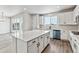 Modern kitchen with white cabinets and a large island at 17751 E 93Rd Ave, Commerce City, CO 80022