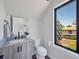 Small bathroom with modern vanity and large window at 6812 Carr St, Arvada, CO 80004