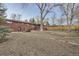 View of the backyard featuring a brick house and mature trees at 8060 Meade St, Westminster, CO 80031