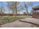 Fenced backyard with patio and mature trees at 8060 Meade St, Westminster, CO 80031