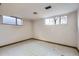 Unfinished basement area with tiled floors and natural light from the windows at 8060 Meade St, Westminster, CO 80031