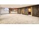 Finished basement with a bar, wood paneling, and carpeted floors at 8060 Meade St, Westminster, CO 80031