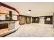 Basement living space features a bar, wood paneling, and carpeted floors at 8060 Meade St, Westminster, CO 80031