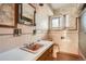 Retro bathroom features a pink sink and toilet, floral wallpaper, and a functional vanity at 8060 Meade St, Westminster, CO 80031