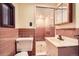 Retro full bathroom featuring a walk-in shower and pink tile at 8060 Meade St, Westminster, CO 80031