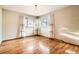 Bedroom features two windows with hardwood floors and a chandelier at 8060 Meade St, Westminster, CO 80031