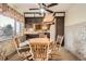 Charming dining area features an octagonal wood table, comfortable seating, and a ceiling fan at 8060 Meade St, Westminster, CO 80031