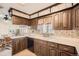 Cozy kitchen features wood cabinets, white countertops and an undermount sink with a window view at 8060 Meade St, Westminster, CO 80031