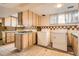 Kitchen with light wood cabinets, gas stove, and laundry machines at 8060 Meade St, Westminster, CO 80031