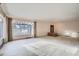 Spacious living room featuring large windows and carpeted floors at 8060 Meade St, Westminster, CO 80031