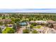 Scenic aerial view of the property, showcasing the lush greenery, tennis court, and community buildings at 13661 E Marina Dr # 406, Aurora, CO 80014