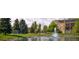 Beautiful pond with a fountain surrounded by green lawns and lush landscaping at 13661 E Marina Dr # 406, Aurora, CO 80014