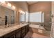 Large bathroom features double sinks, granite counters, soaking tub, and glass enclosed shower at 6271 Mcintyre Way, Golden, CO 80403
