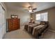 Comfortable bedroom with a ceiling fan, carpet floors, and natural light from a large window at 6271 Mcintyre Way, Golden, CO 80403
