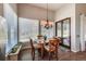 Cozy dining area with wood table, chandelier, and large windows with view of outside at 6271 Mcintyre Way, Golden, CO 80403