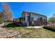 Back exterior with a brick and siding combination, including a covered patio and well-manicured lawn at 6271 Mcintyre Way, Golden, CO 80403
