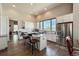 Sun-lit kitchen with stainless steel appliances, marble countertops, and island seating at 6271 Mcintyre Way, Golden, CO 80403