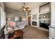Comfortable living room featuring a fireplace, built-in shelving, and a ceiling fan at 6271 Mcintyre Way, Golden, CO 80403