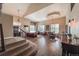 Open-concept living area with hardwood floors, stylish furnishings, and a grand staircase, creating an inviting ambiance at 6271 Mcintyre Way, Golden, CO 80403