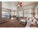 Open-concept living room features large windows and flows into the kitchen and dining area at 6271 Mcintyre Way, Golden, CO 80403