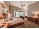 Large main bedroom with vaulted ceiling, wood furniture, and a relaxing sitting area by the window at 6271 Mcintyre Way, Golden, CO 80403