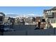 Backyard view with snow-capped mountain range, play structure and fenced yard at 1160 Acadia Cir, Erie, CO 80516