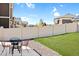 Backyard with a grassy lawn, privacy fence, and patio with a table and chairs at 1160 Acadia Cir, Erie, CO 80516