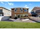 Exterior shot of the back of the home with patio, furniture, lawn, and privacy fence at 1160 Acadia Cir, Erie, CO 80516