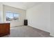 Comfortable bedroom with soft carpet, neutral walls, and natural light from large window at 1160 Acadia Cir, Erie, CO 80516