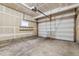Spacious two-car garage with an automatic door and concrete flooring, perfect for storage and parking at 1160 Acadia Cir, Erie, CO 80516