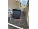 Exterior view of HVAC unit with gravel surround and a walkway between the house and fence at 1160 Acadia Cir, Erie, CO 80516