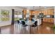 Bright eat-in kitchen featuring modern appliances, hardwood floors, and a stylish dining table with backyard access at 1160 Acadia Cir, Erie, CO 80516