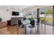 Open-concept living area with hardwood floors, a modern dining table, and a comfortable sofa, ideal for entertaining and relaxation at 1160 Acadia Cir, Erie, CO 80516