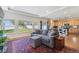 Spacious living room open to the kitchen, featuring hardwood floors, a comfortable sofa, and large windows overlooking the backyard at 1160 Acadia Cir, Erie, CO 80516