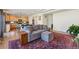 Open-concept living area with hardwood floors, a comfortable sofa, and views into the kitchen, perfect for modern living at 1160 Acadia Cir, Erie, CO 80516