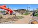 Community playground with a slide and stairs leading to the community clubhouse at 1160 Acadia Cir, Erie, CO 80516