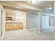 This wet bar in the basement has light colored cabinets and carpet flooring at 119 Lake Ave, Palmer Lake, CO 80133